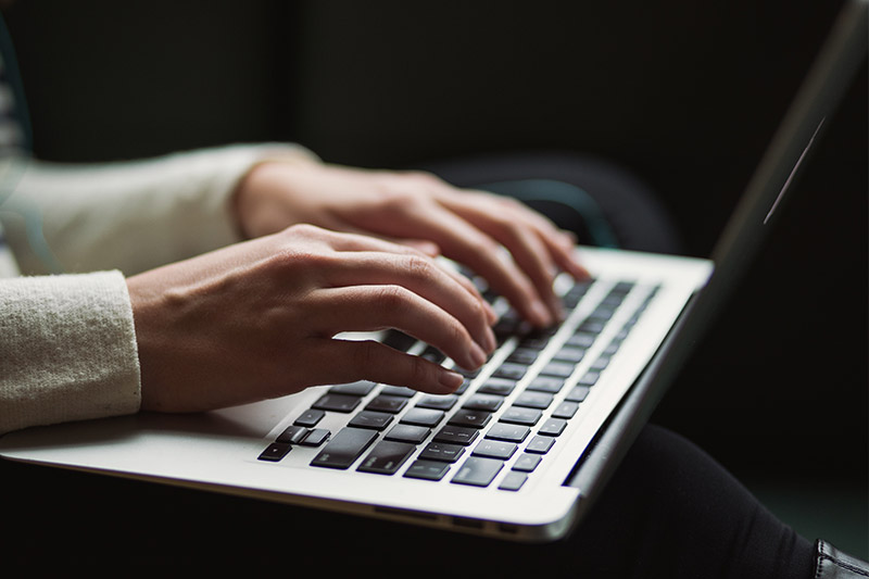 Typing on laptop