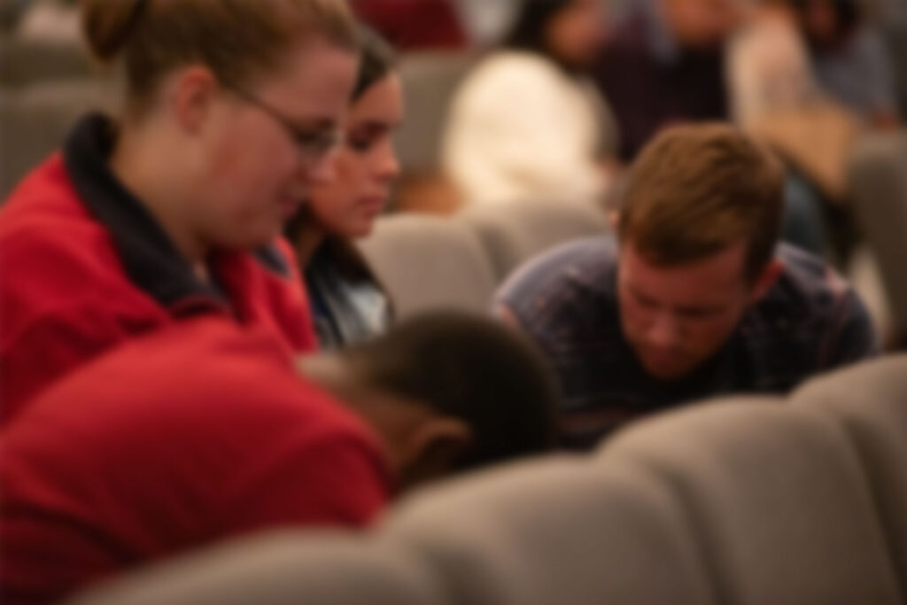 Church members praying together at church