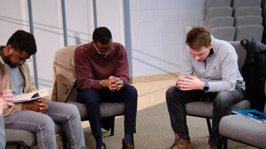Group of people praying together