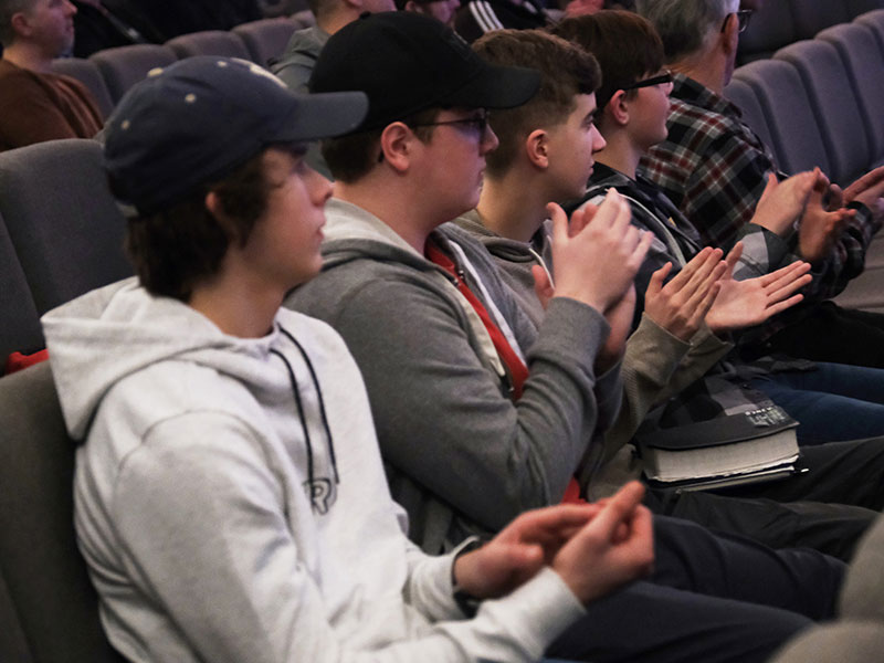 Group of men sitting in service