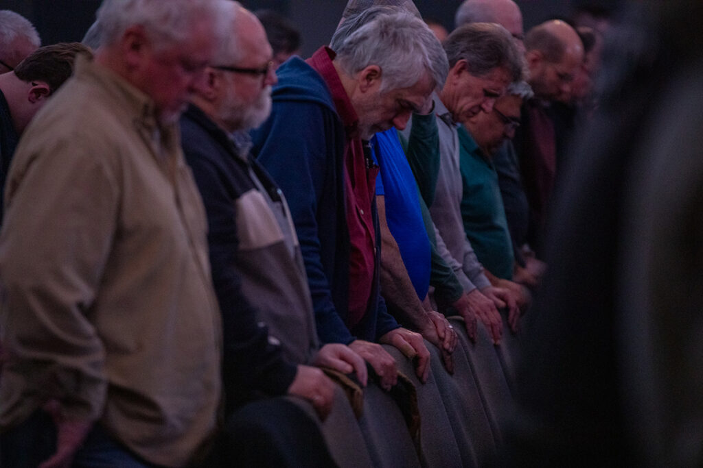Group of men praying together