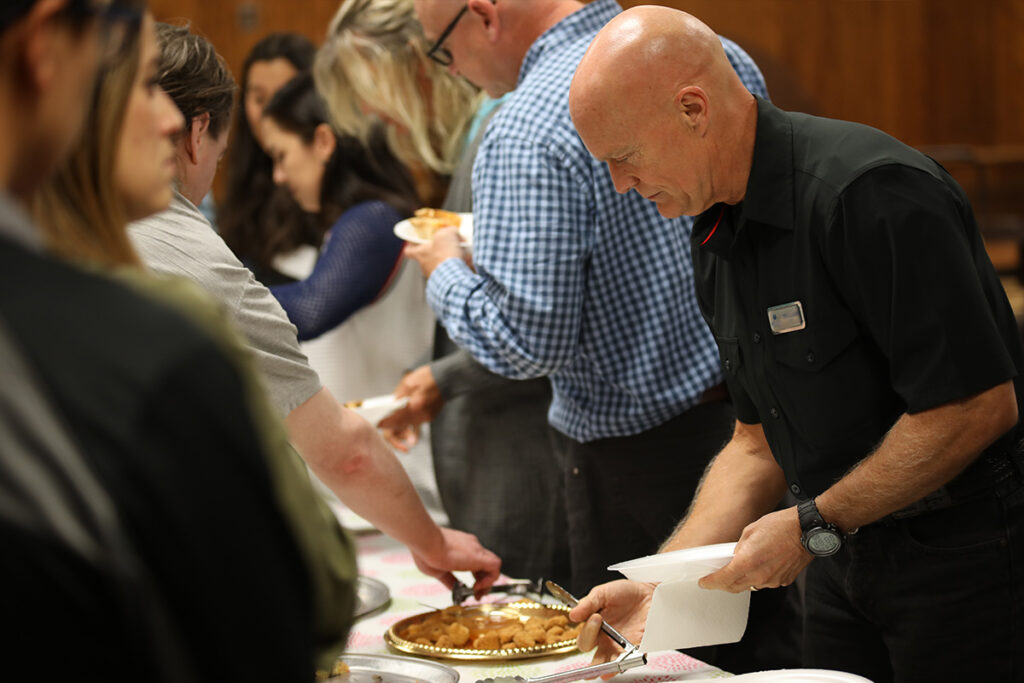 Group of people fellowshipping and getting food