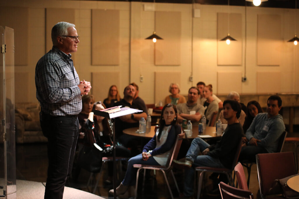 Norm leading a discussion with a group of new attendees at the church