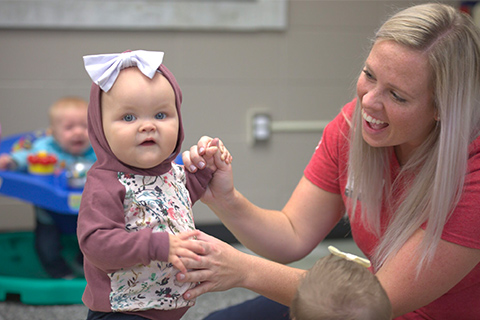 Young child with nursery worker