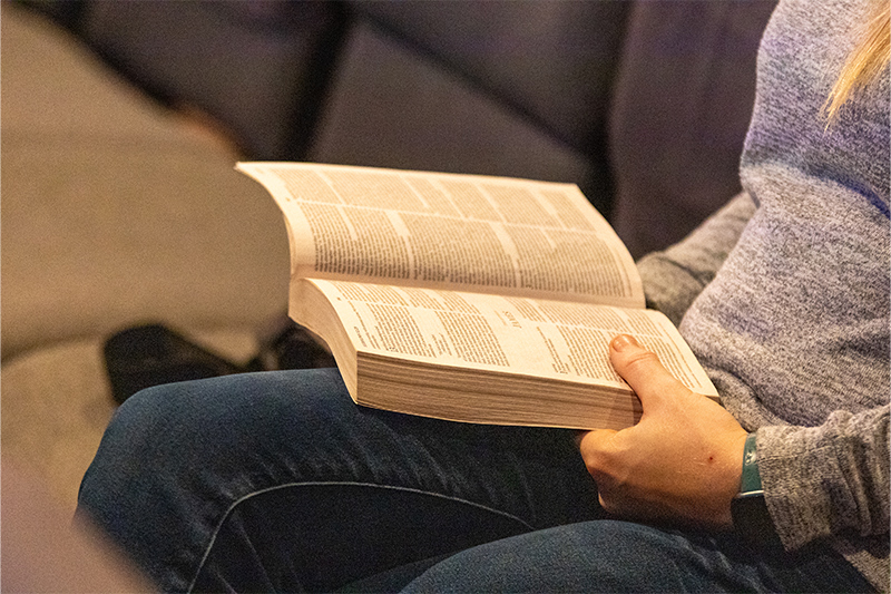 Studying Bible on lap