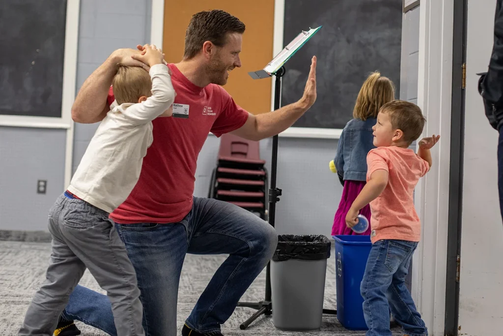 Teacher welcoming student in