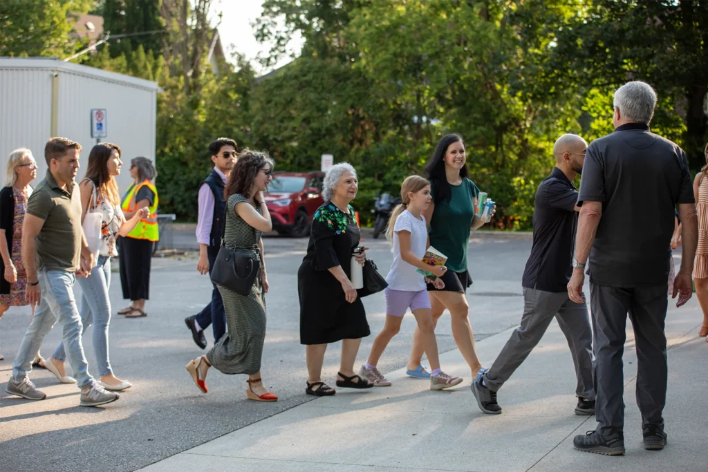 A line up of people walking into church from the front doors
