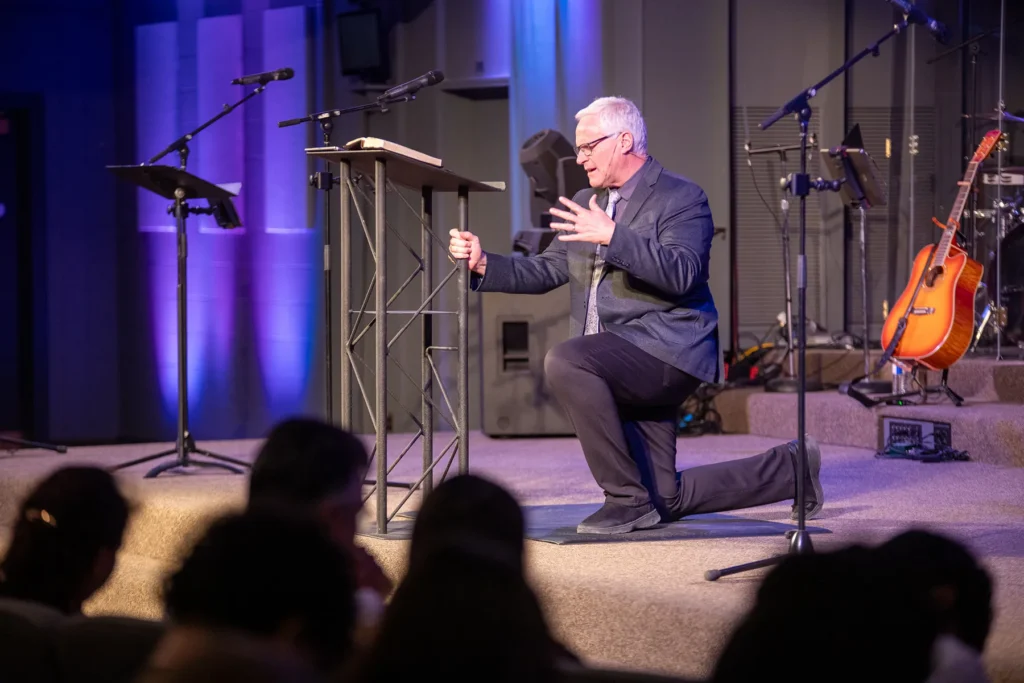Norm Millar kneeling in prayer