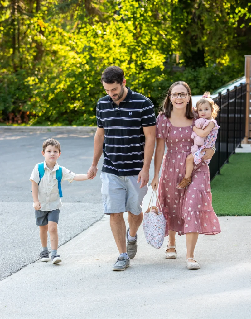 A family with young children walking into church