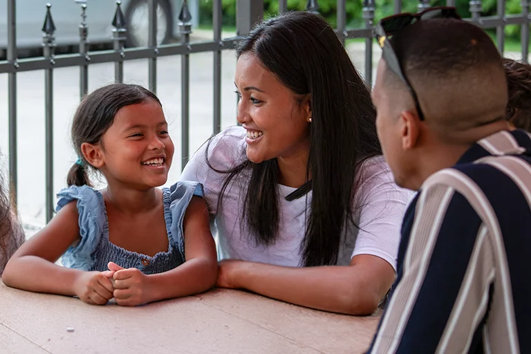 A family sitting outdoors after church service