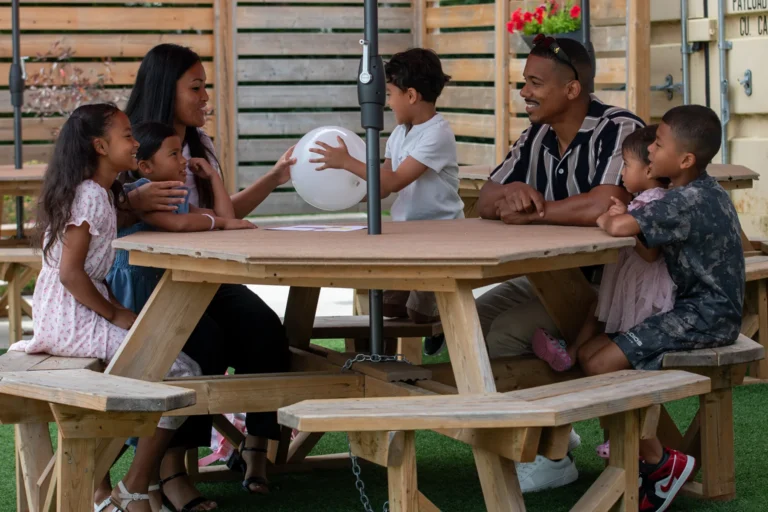 A family sitting on picnic table after church