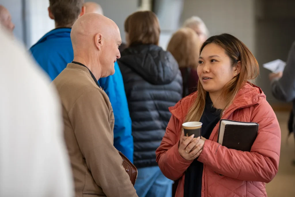Girl speaking to an elder at Redemption Bible Chapel