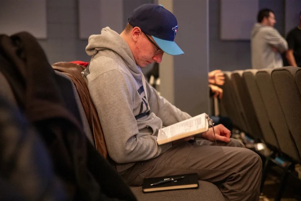 A man sitting and reading his Bible at church