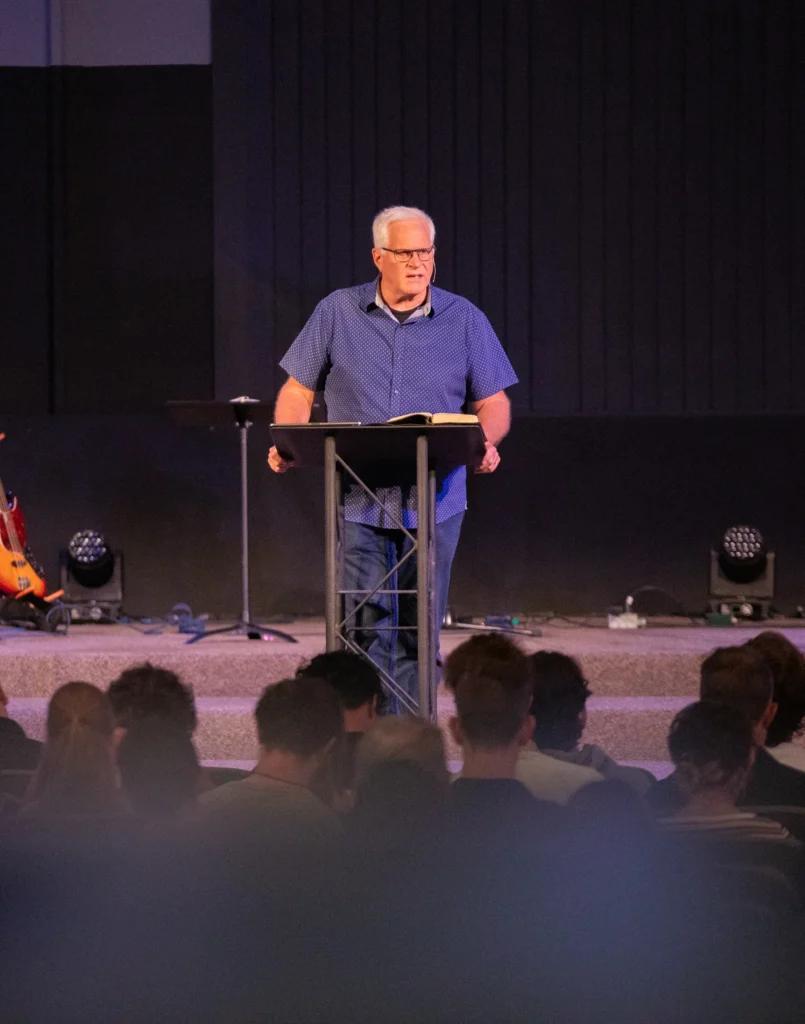 Norm Millar preaching from pulpit