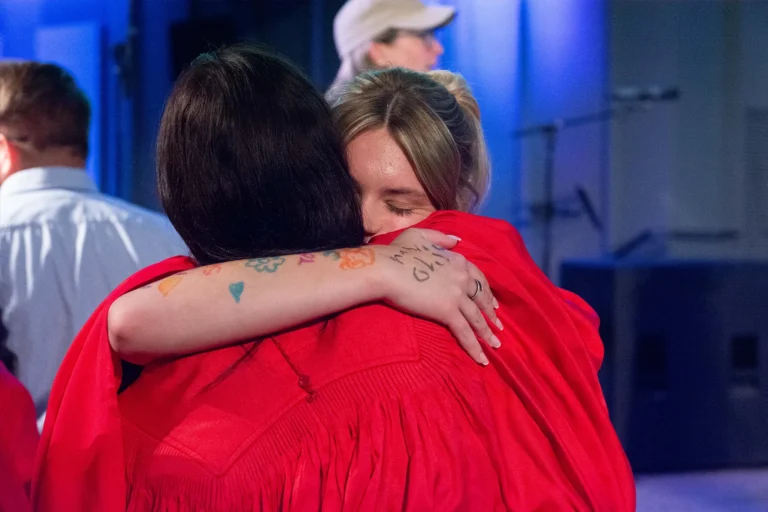 Two youth hugging