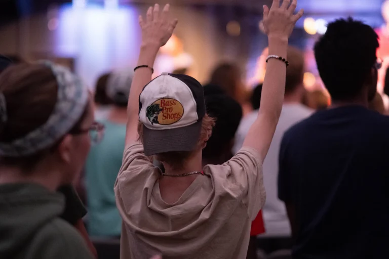 Youth with hands raised in worship