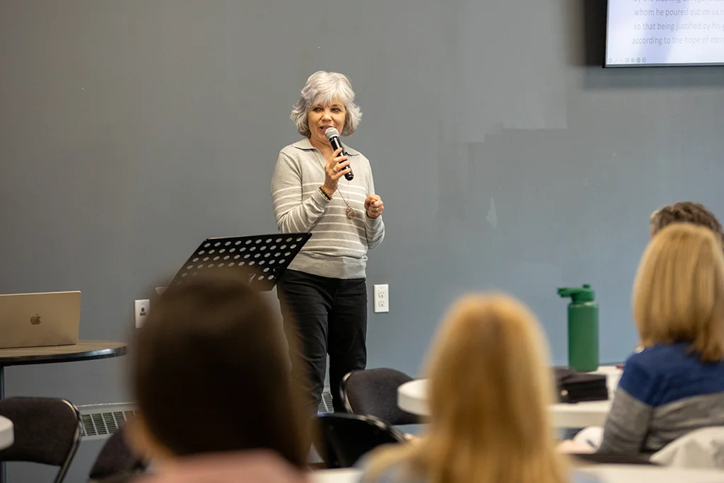 Woman speaking at front of class
