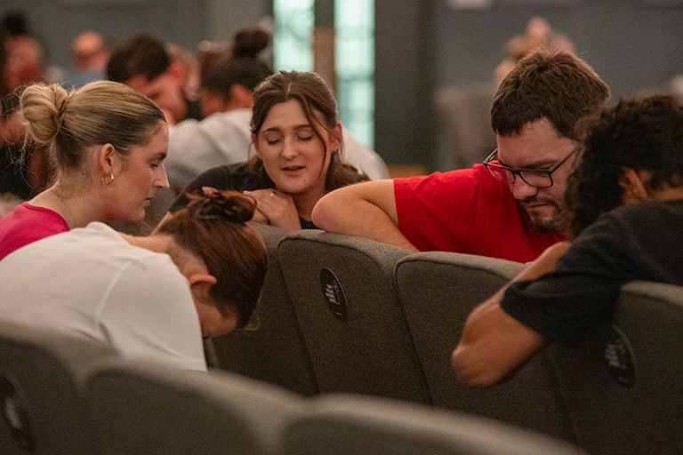 A group of people praying together at church